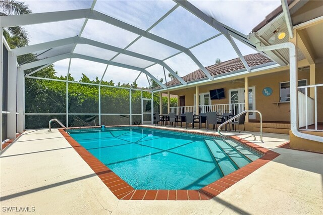 view of pool featuring a patio and glass enclosure