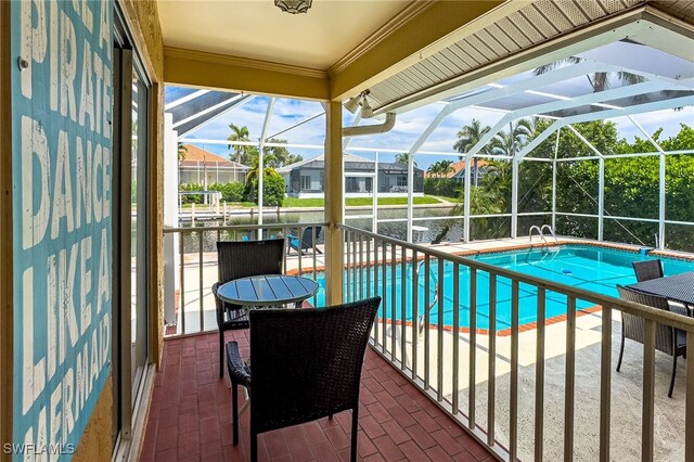 view of pool with glass enclosure and a patio area