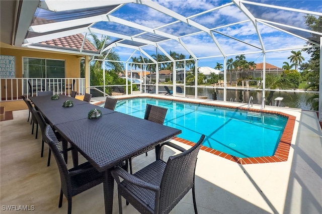 view of pool featuring a lanai, a patio, and a water view