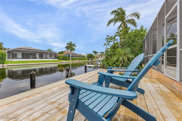 view of dock featuring a water view and a lanai