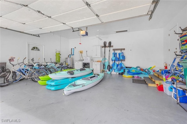 garage with a garage door opener and washing machine and clothes dryer