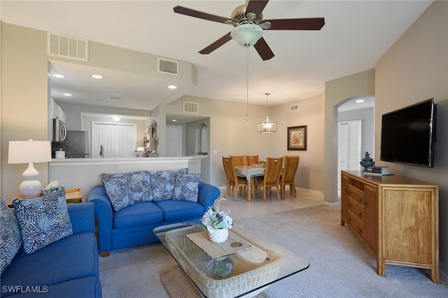 living room featuring light carpet and ceiling fan