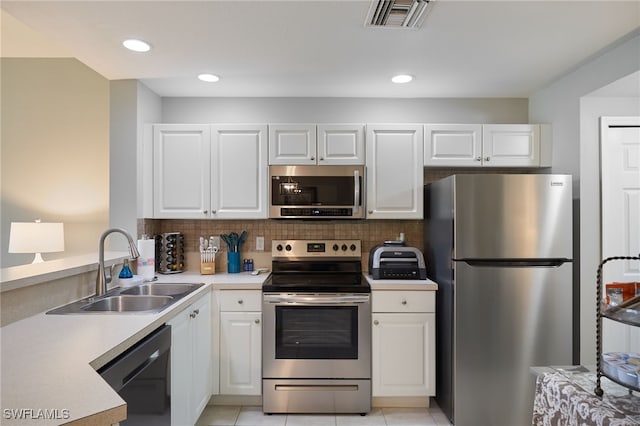 kitchen featuring sink, stainless steel appliances, and white cabinets