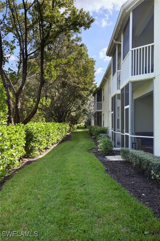 view of yard with a balcony