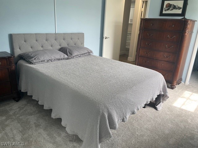 bedroom featuring light colored carpet