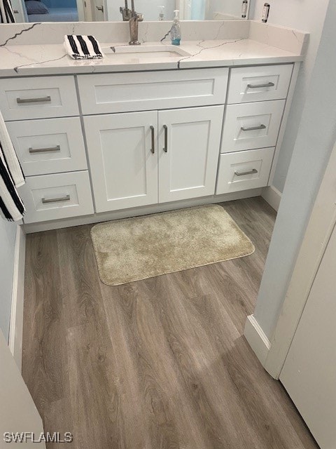 bathroom featuring vanity and hardwood / wood-style floors