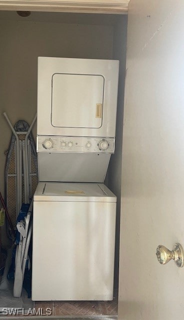 clothes washing area with stacked washer / drying machine