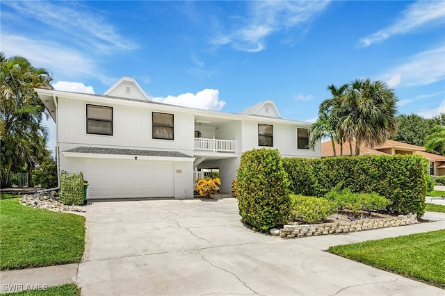 view of front of property with a garage and a balcony