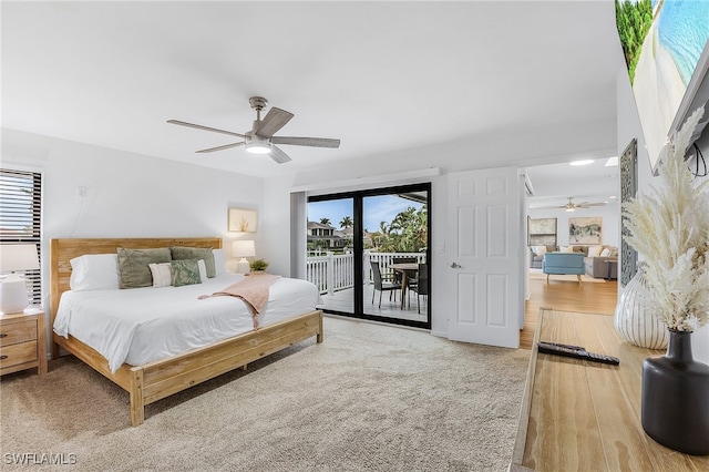 bedroom featuring ceiling fan, access to exterior, and wood-type flooring