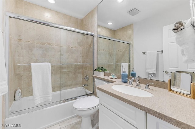 full bathroom with vanity, tile patterned floors, toilet, and combined bath / shower with glass door