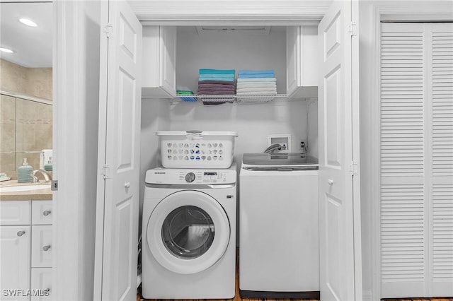 clothes washing area with sink and washer and dryer