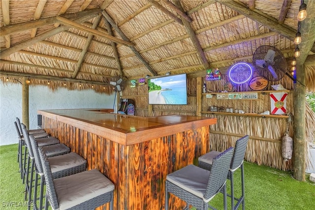 exterior space with lofted ceiling and carpet flooring