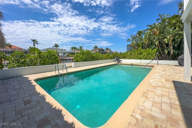 view of swimming pool featuring a patio area