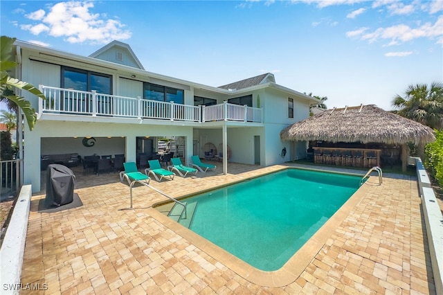 view of pool with exterior bar and a patio