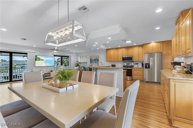 dining area featuring ceiling fan and light hardwood / wood-style flooring