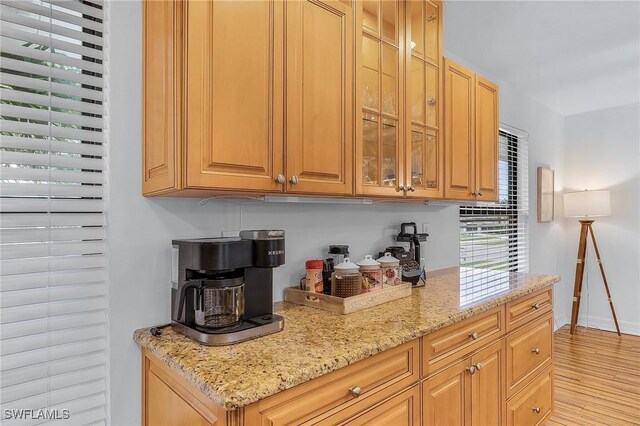 kitchen with light stone counters and light hardwood / wood-style floors