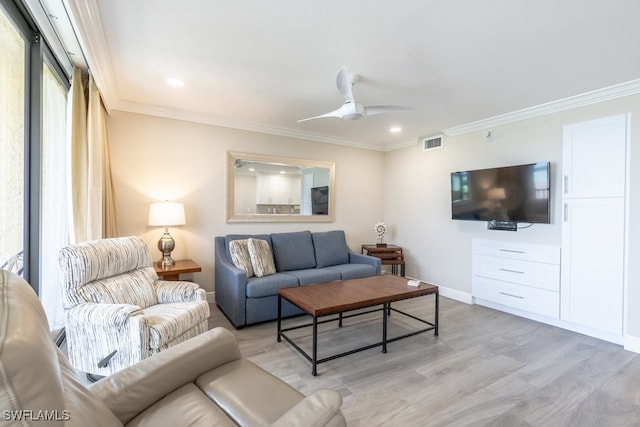 living room featuring ornamental molding, light wood-type flooring, and ceiling fan