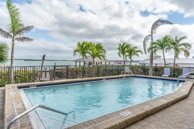 view of swimming pool with a water view