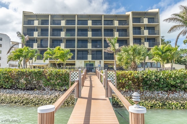 view of dock featuring a balcony and a water view