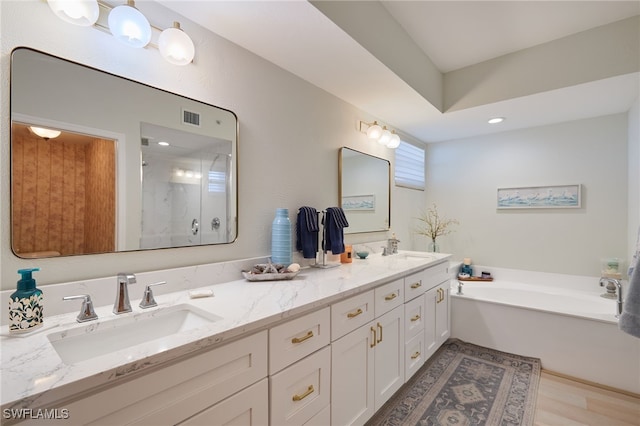 bathroom featuring vanity, wood-type flooring, and plus walk in shower