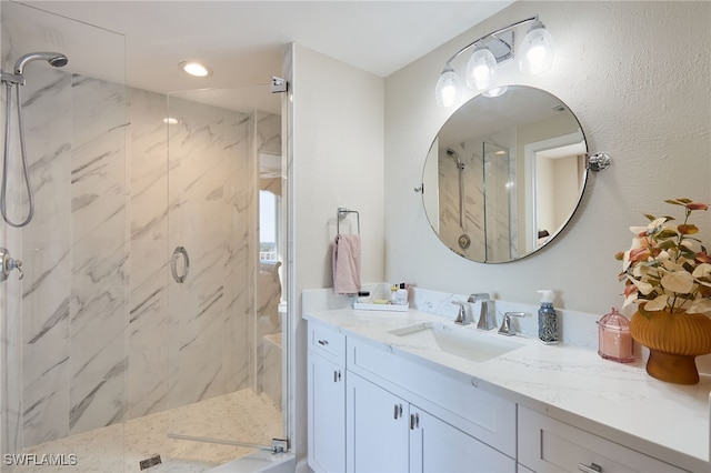 bathroom with vanity and a shower with shower door