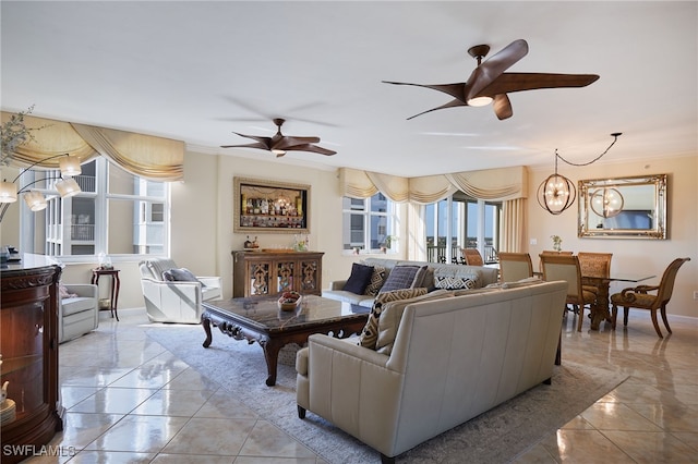 living room featuring crown molding, a healthy amount of sunlight, and ceiling fan with notable chandelier