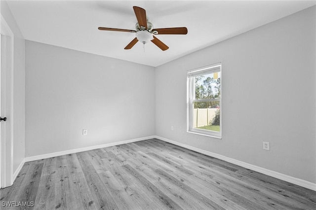 empty room featuring ceiling fan and light hardwood / wood-style floors