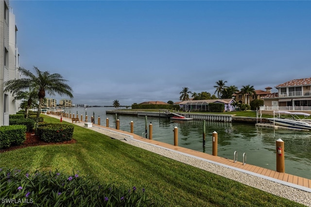 view of dock featuring a yard and a water view