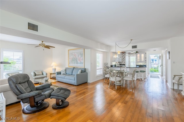 living room featuring ceiling fan and light hardwood / wood-style flooring