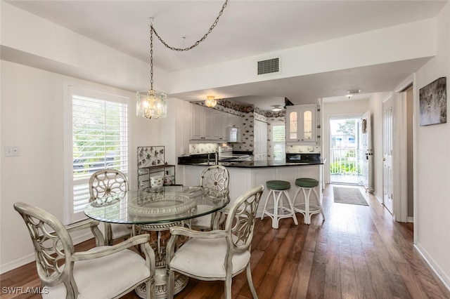 dining area featuring a notable chandelier and hardwood / wood-style flooring