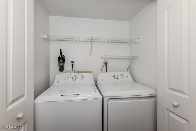 washroom with washing machine and clothes dryer