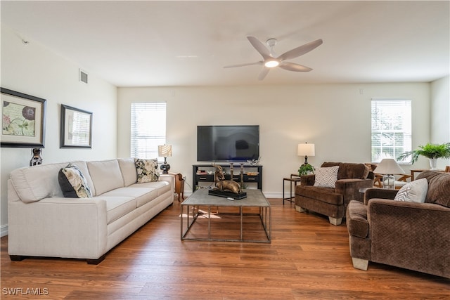 living room with a wealth of natural light, hardwood / wood-style floors, and ceiling fan