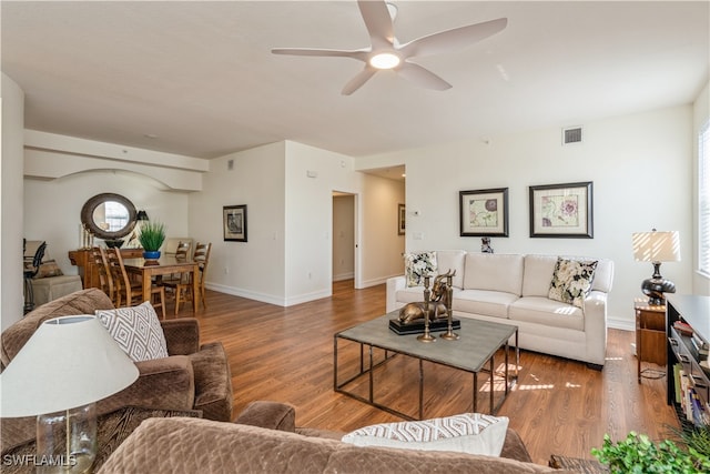 living room featuring hardwood / wood-style flooring and ceiling fan