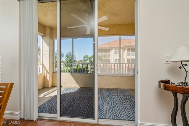 entryway with hardwood / wood-style floors, a textured ceiling, and ceiling fan