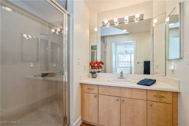 bathroom with vanity and a shower with door