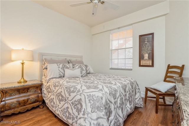 bedroom with wood-type flooring and ceiling fan