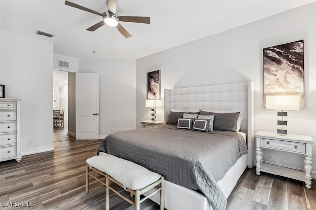 bedroom with ceiling fan and dark hardwood / wood-style flooring