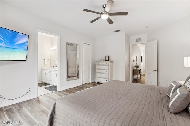 unfurnished bedroom with light wood-type flooring, ensuite bath, and ceiling fan