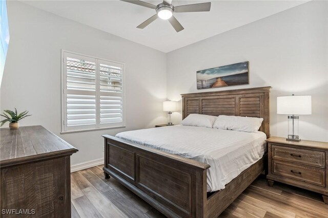 bedroom with ceiling fan and wood-type flooring