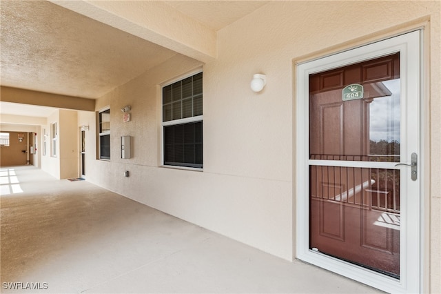 view of exterior entry featuring stucco siding