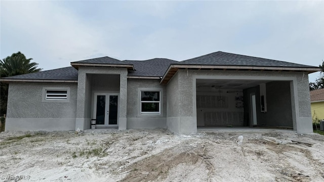 prairie-style house with french doors and a garage