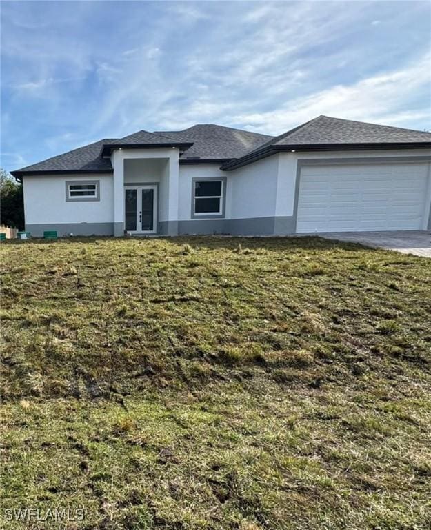 view of front facade featuring a garage and a front lawn