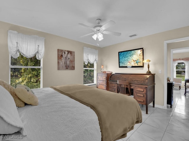 bedroom with ceiling fan and light tile patterned flooring