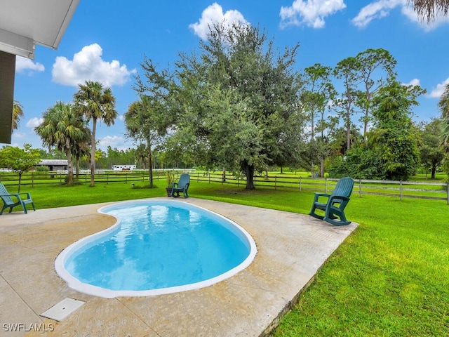 view of pool with a lawn and a patio