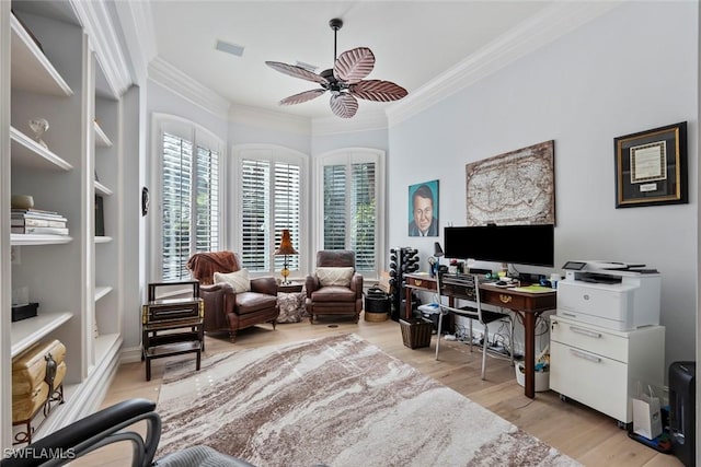 home office featuring built in shelves, light hardwood / wood-style flooring, ceiling fan, and crown molding