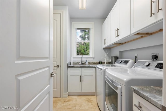 laundry area with cabinets, sink, light tile patterned floors, and washer and dryer