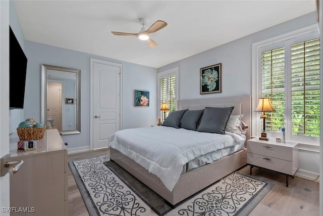 bedroom featuring light hardwood / wood-style flooring and ceiling fan