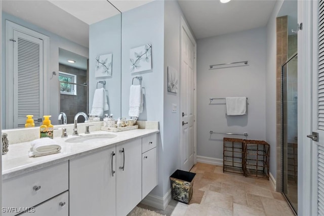 bathroom featuring vanity and a shower with shower door