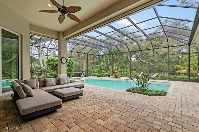 view of swimming pool with outdoor lounge area, a patio area, ceiling fan, and a lanai