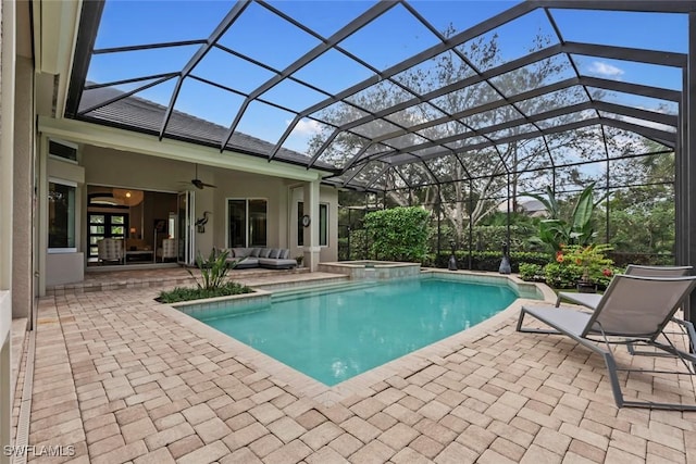 view of pool featuring an outdoor living space, a patio area, ceiling fan, and a lanai